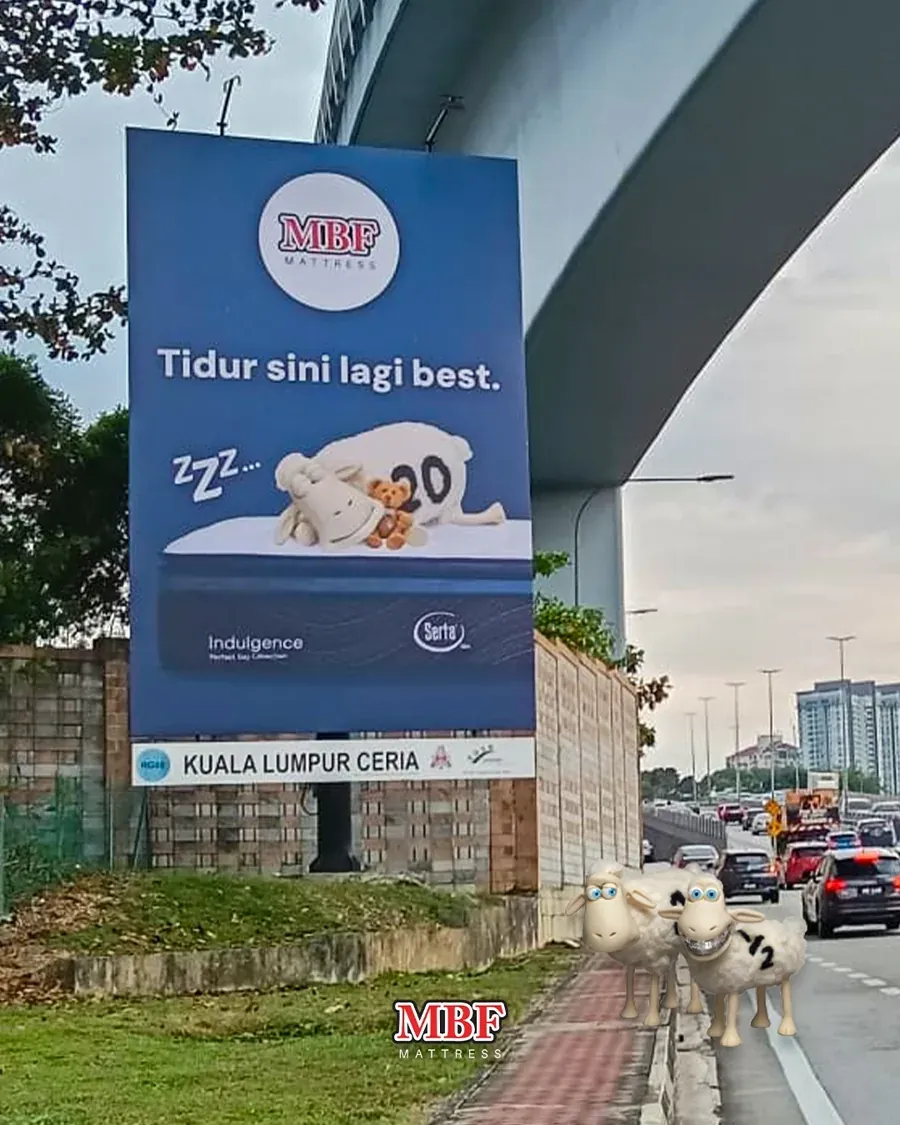 MBF Mattress roadside billboard in Kuala Lumpur reading “Tidur sini lagi best”, with a Serta Indulgence mattress